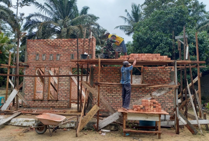 Pelda Heri Asmara Babinsa Koramil 16 Tapung Bantu Pasang Batu Bata Rumah Warga Binaan