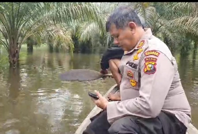 Naiki Perahu Motor, Polisi Bantu Warga Terdampak Banjir dan Cooling System Pemilu Damai