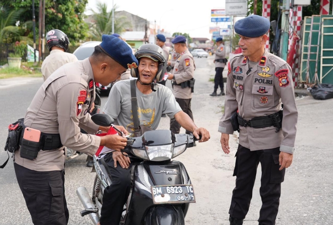 Tingkatkan rasa Nasionalisme, Brimob Polda Riau Bagikan Bendera Merah Putih Ke Masyarakat