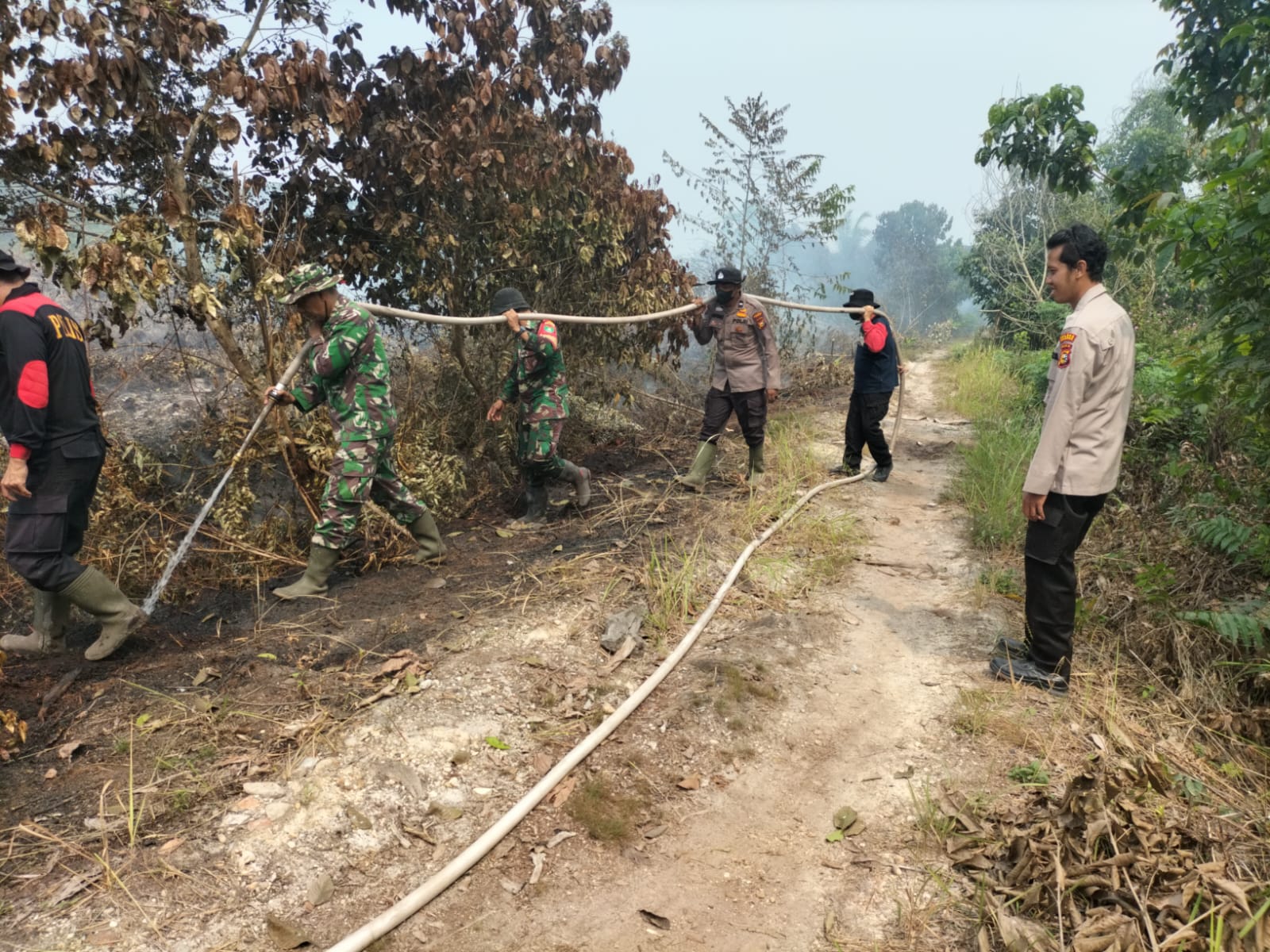 Babinsa Koramil 06 Siak Hulu Bersama Bhabinkamtibmas dan Masyarakat Berjibaku Padamkan Api